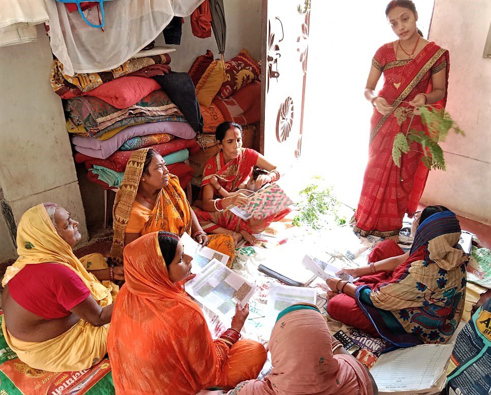 Woman teaching other women about moringa in India