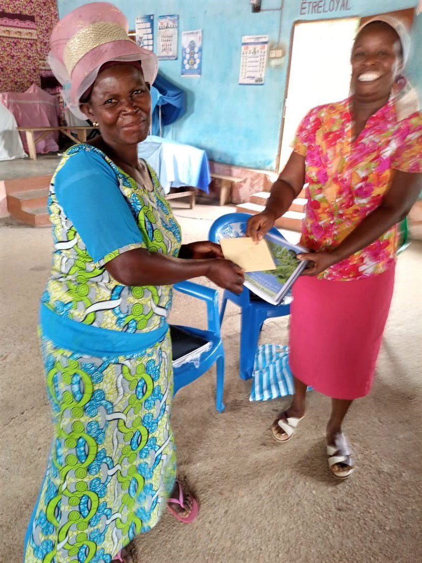 Afi, Togolese woman, receiving Strong Harvest manual and start-up funds