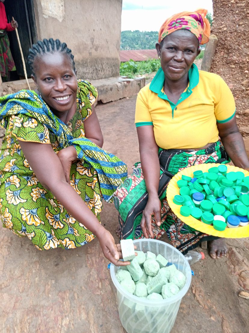In Togo, Afi, at right, holding moringa products with Olga.