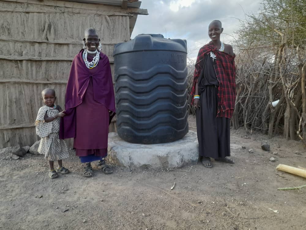 Mother and two daughters with their new water tank